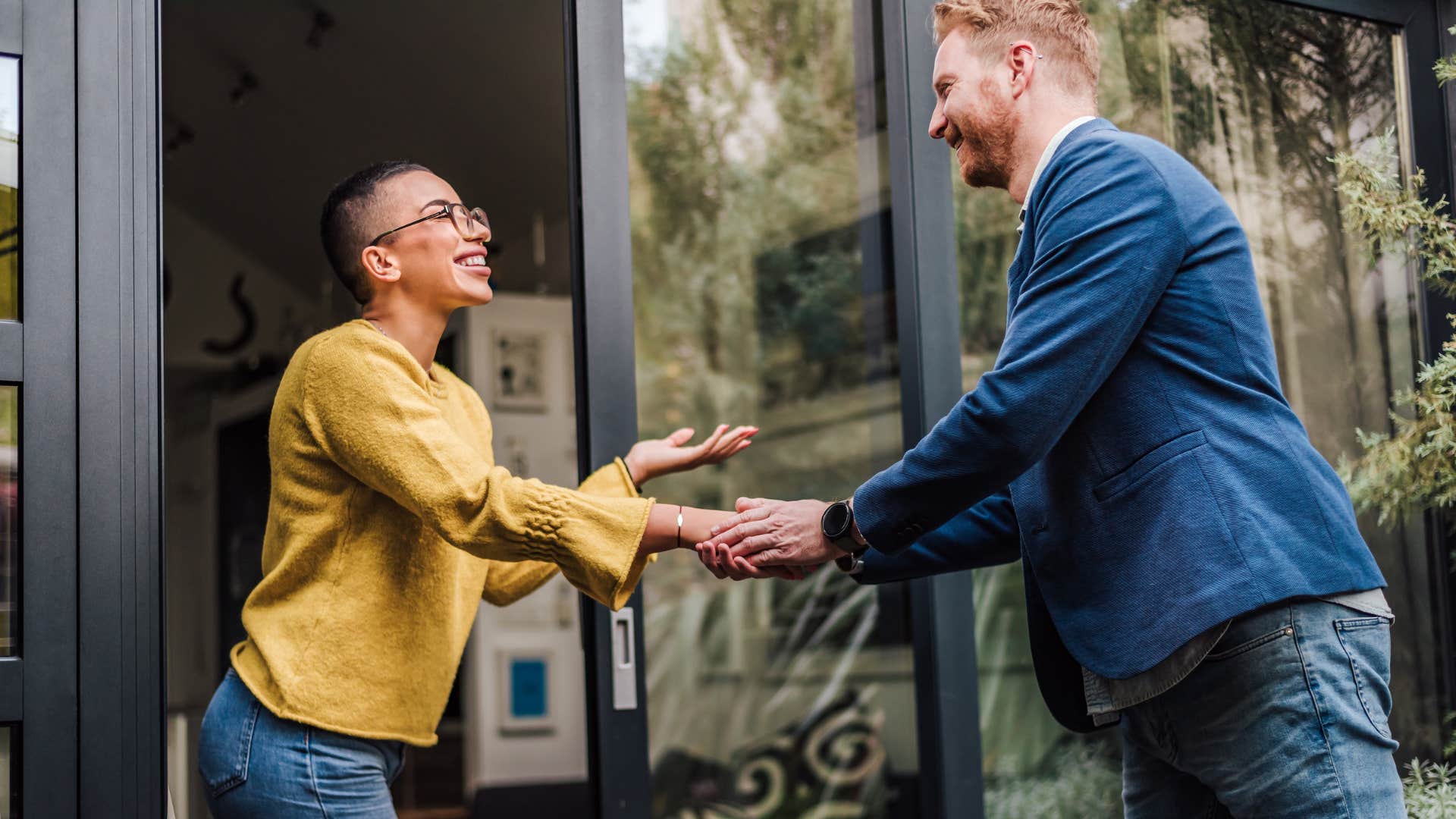 man with no friends shaking hands with woman after helping her