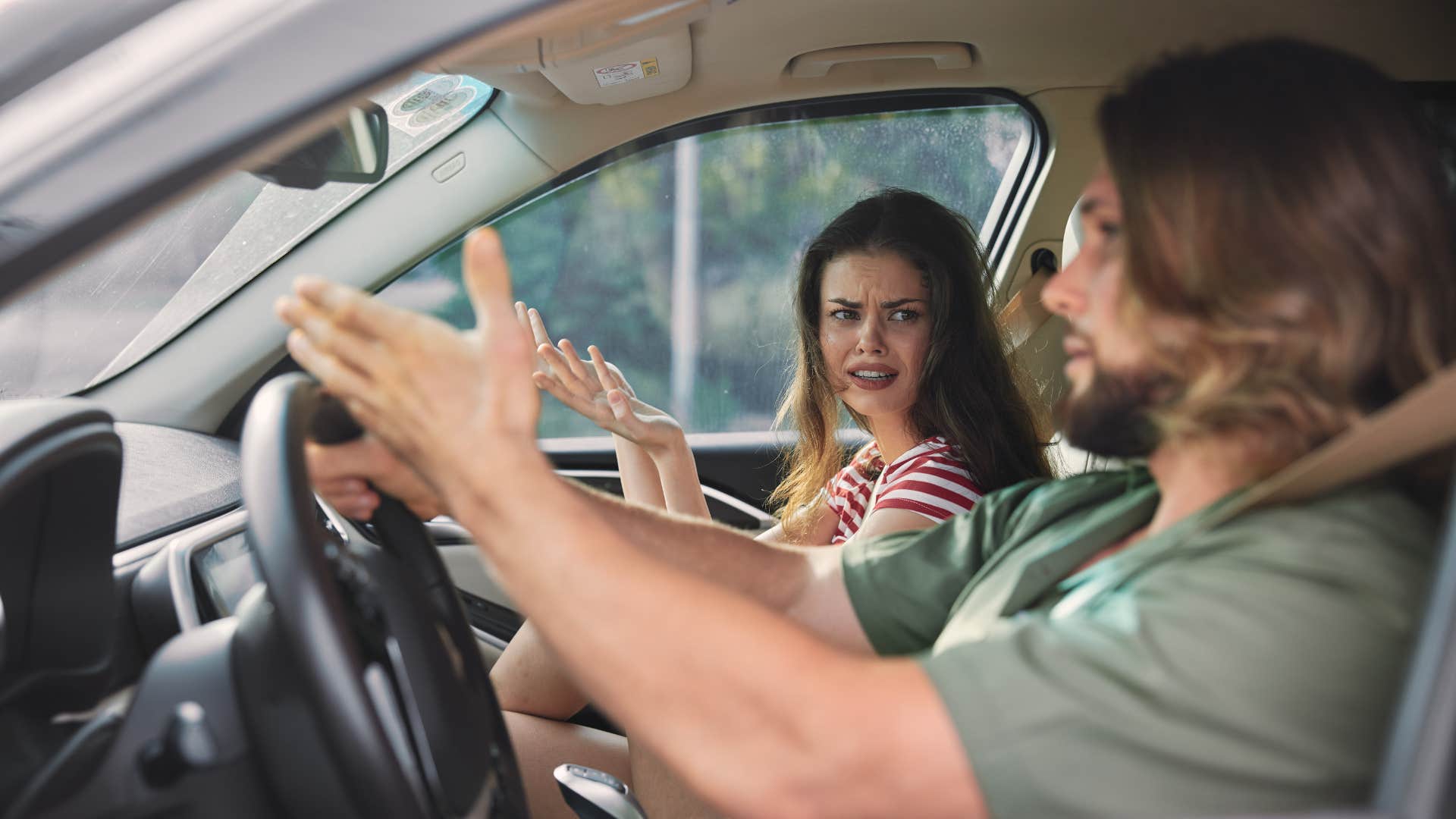 man in car avoiding conflict at all costs with arguing woman