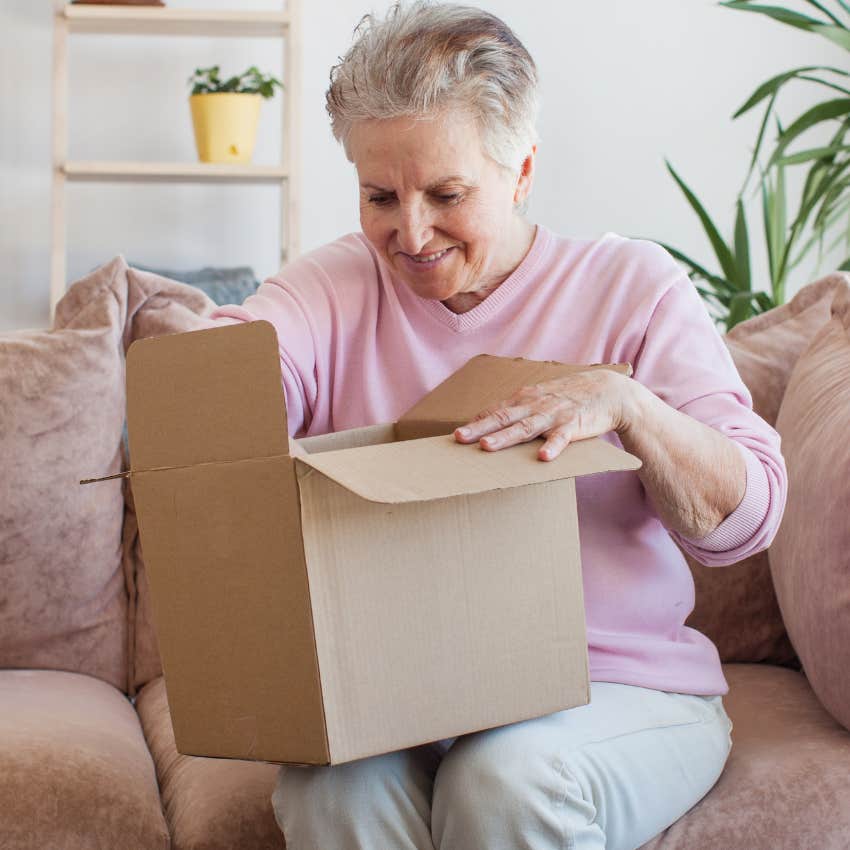 woman opening a package after paying express shipping fees