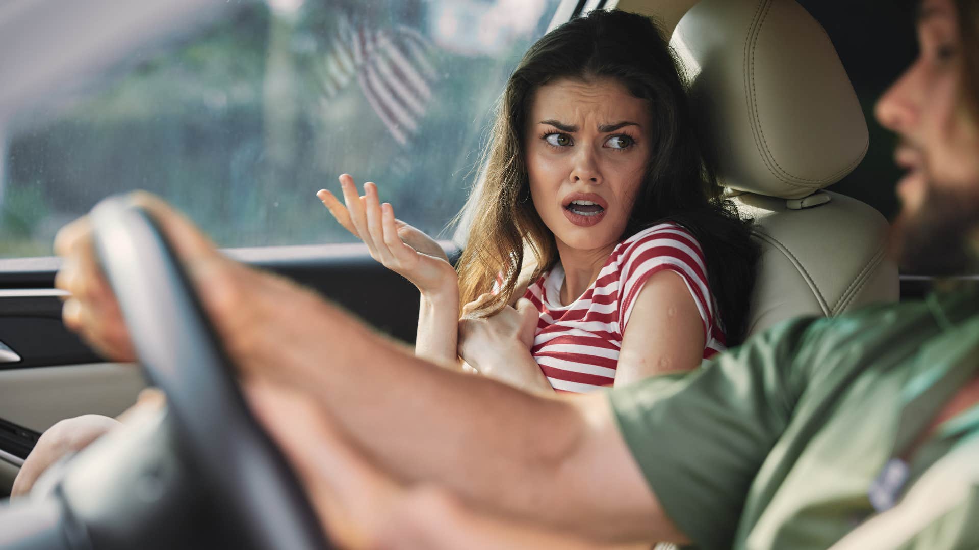 couple in car arguing over man's driving skills