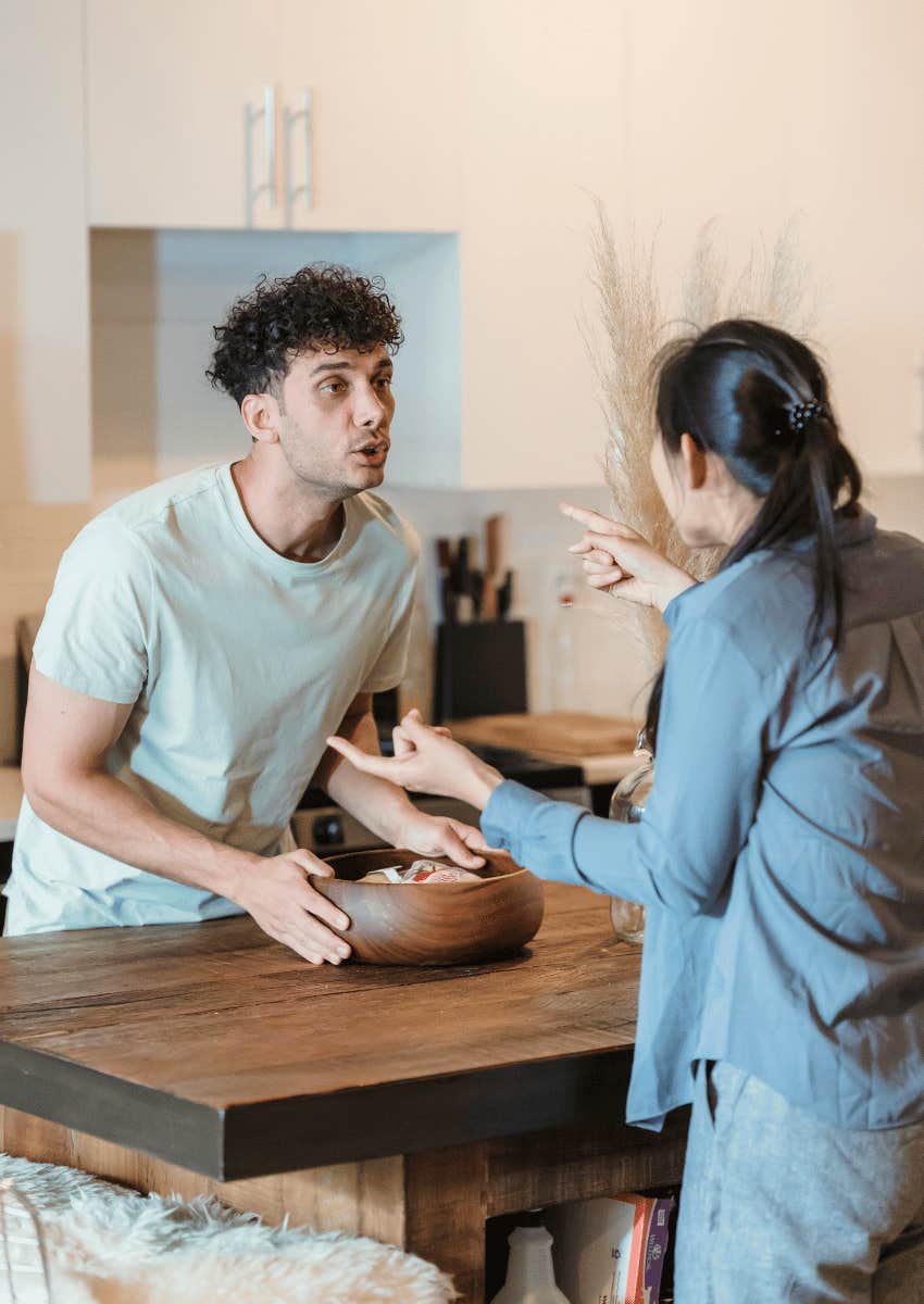 couple arguing across dining toable