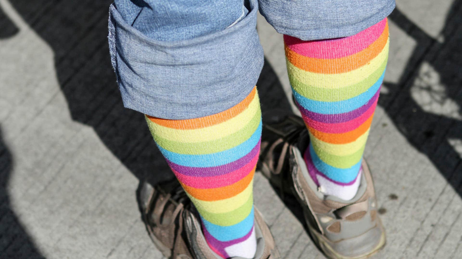 Colorful striped socks with old denim showing repurposed fashion