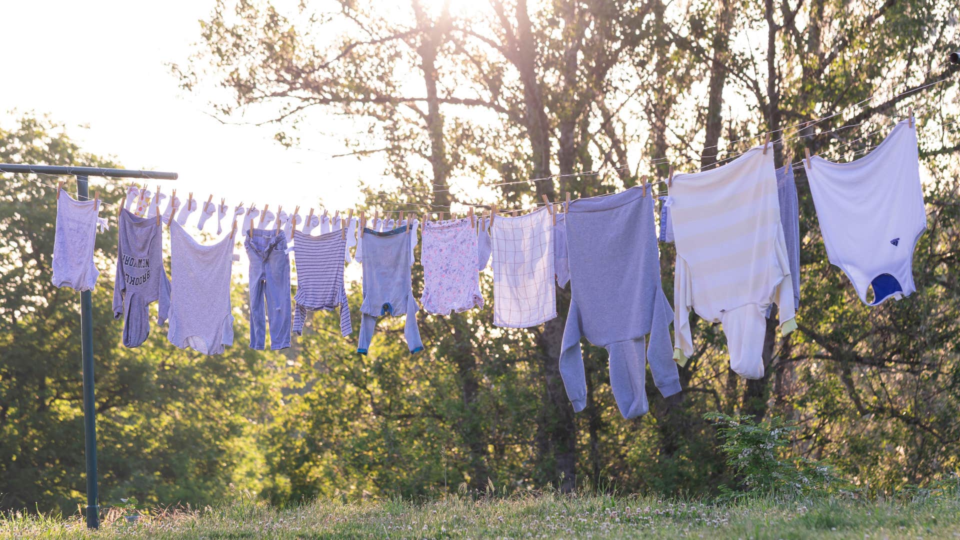 Same color old clothing hangs on line ready to be turned into something creative