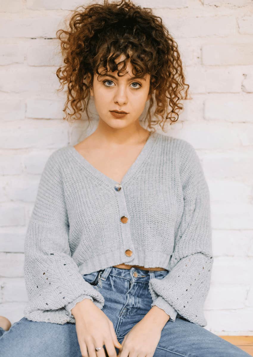 curly haired woman with a serious expression