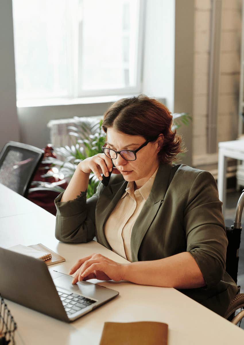 determined woman focused on an open laptop