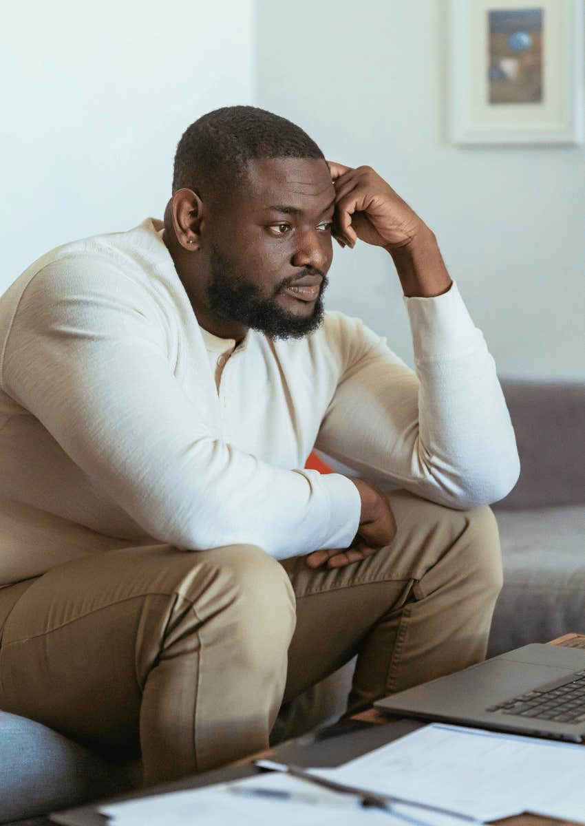 disgruntled man resting his elbows on his knees