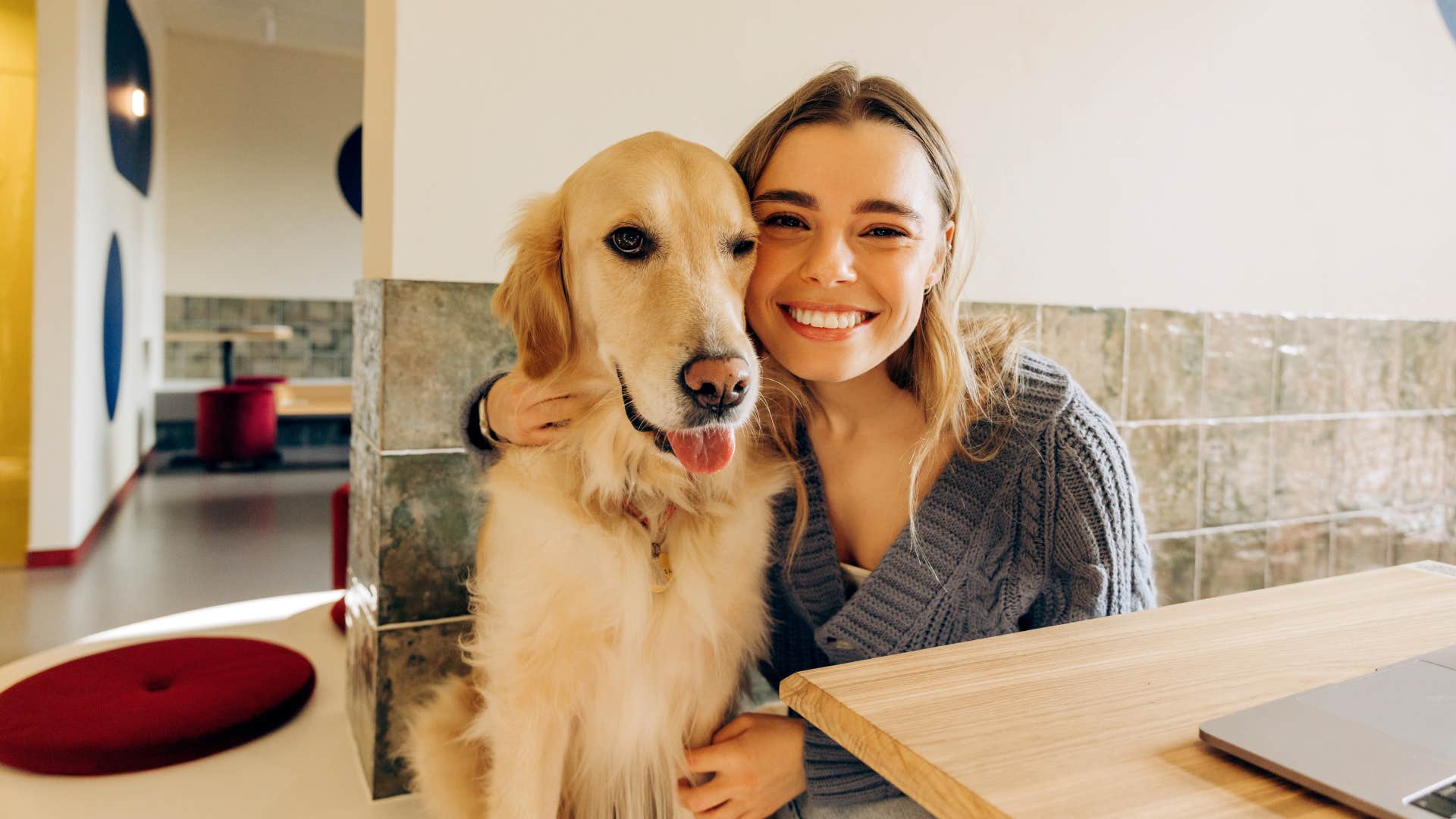 dog sighs deeply when relaxing near woman