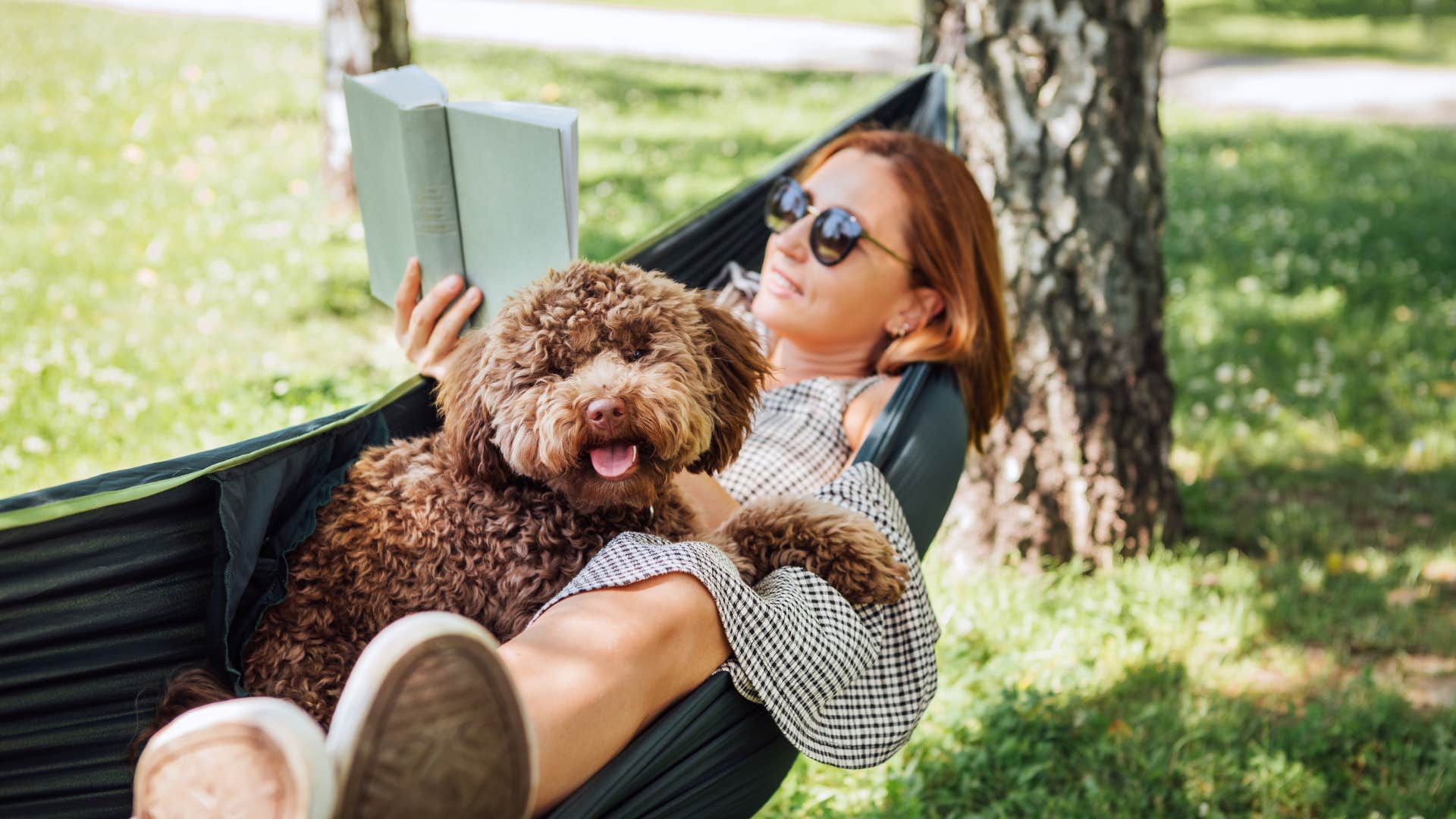 calm woman in a hammock with cute dog