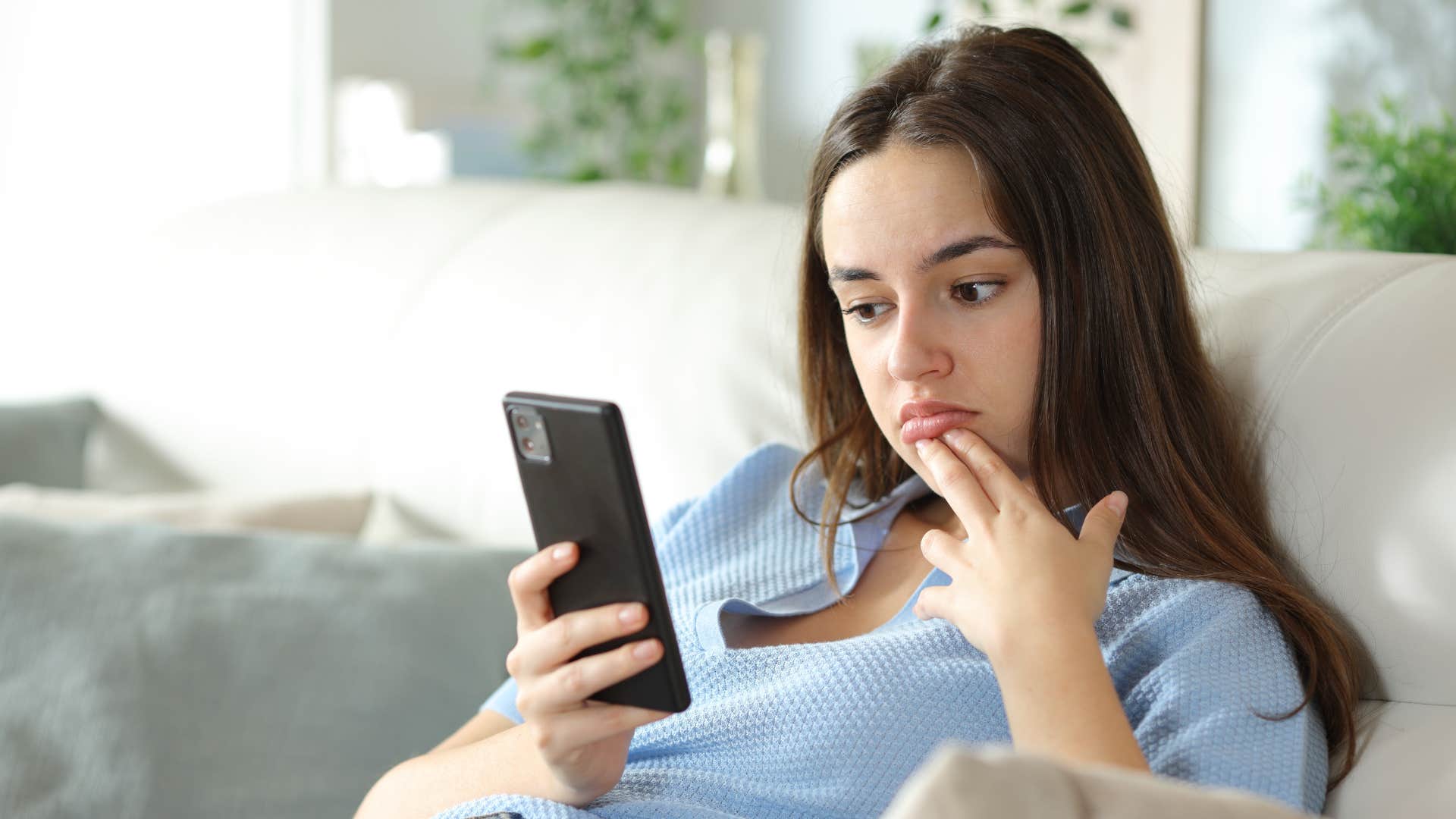 woman looking at group chat on phone
