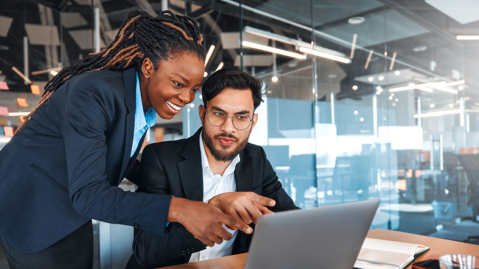 colleague helping man at work