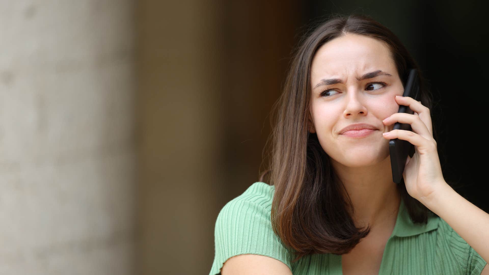woman on phone listening to person who talks in circles