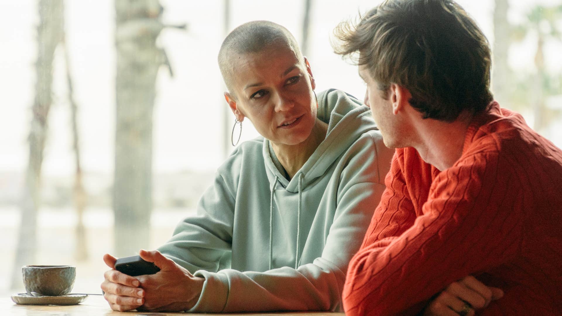 Woman saying "I'll just pretend you didn't say that" to a man at home.