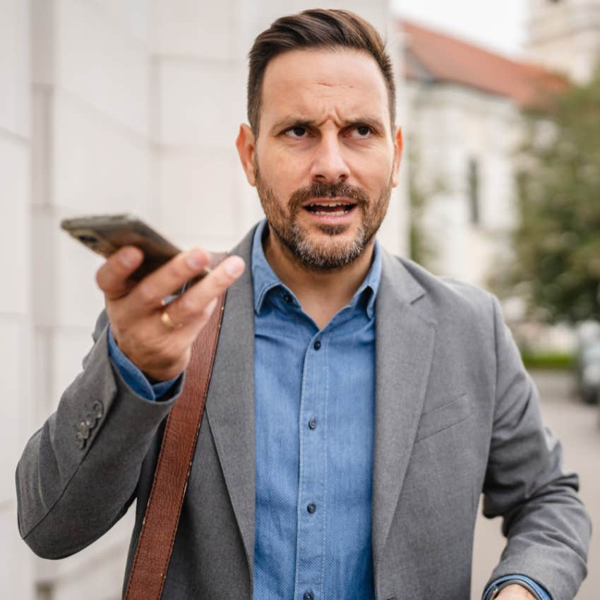 man leaving voicemails on his phone while walking