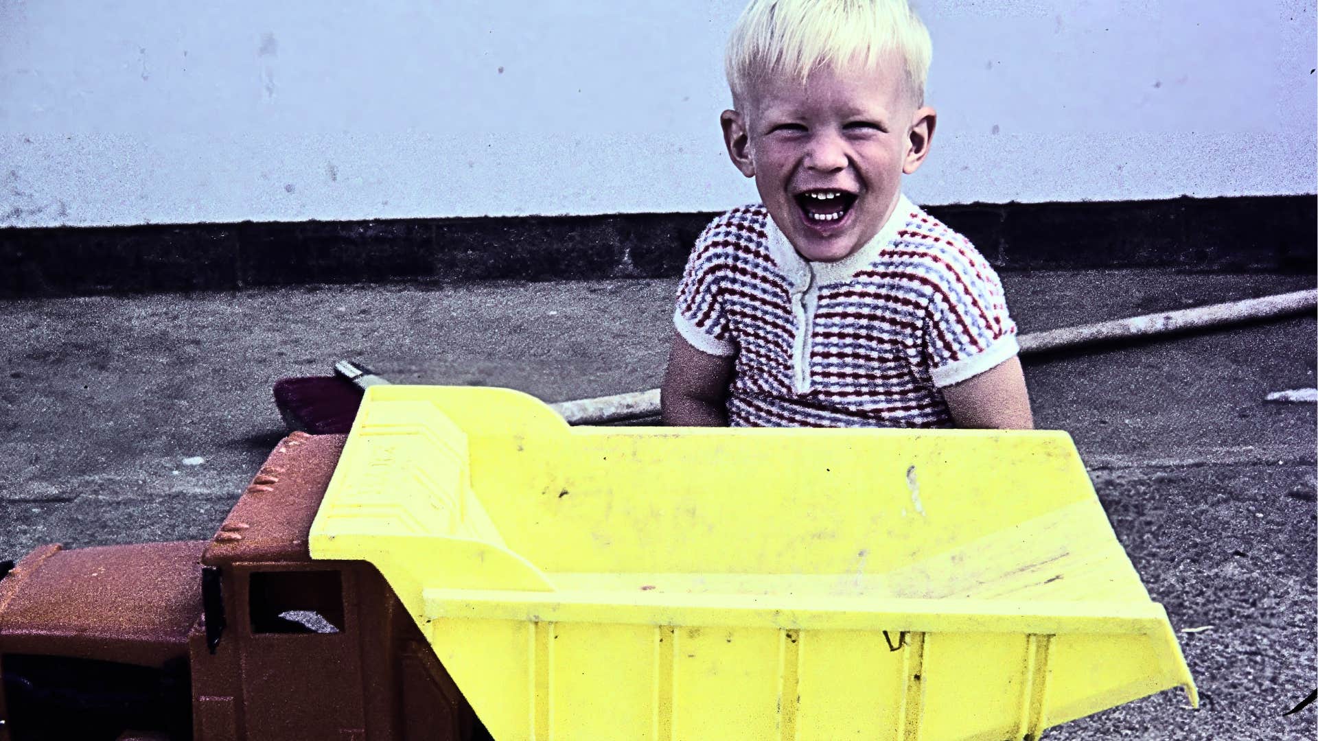 Vintage photo happy boy with toy truck showing acceptance was expected 