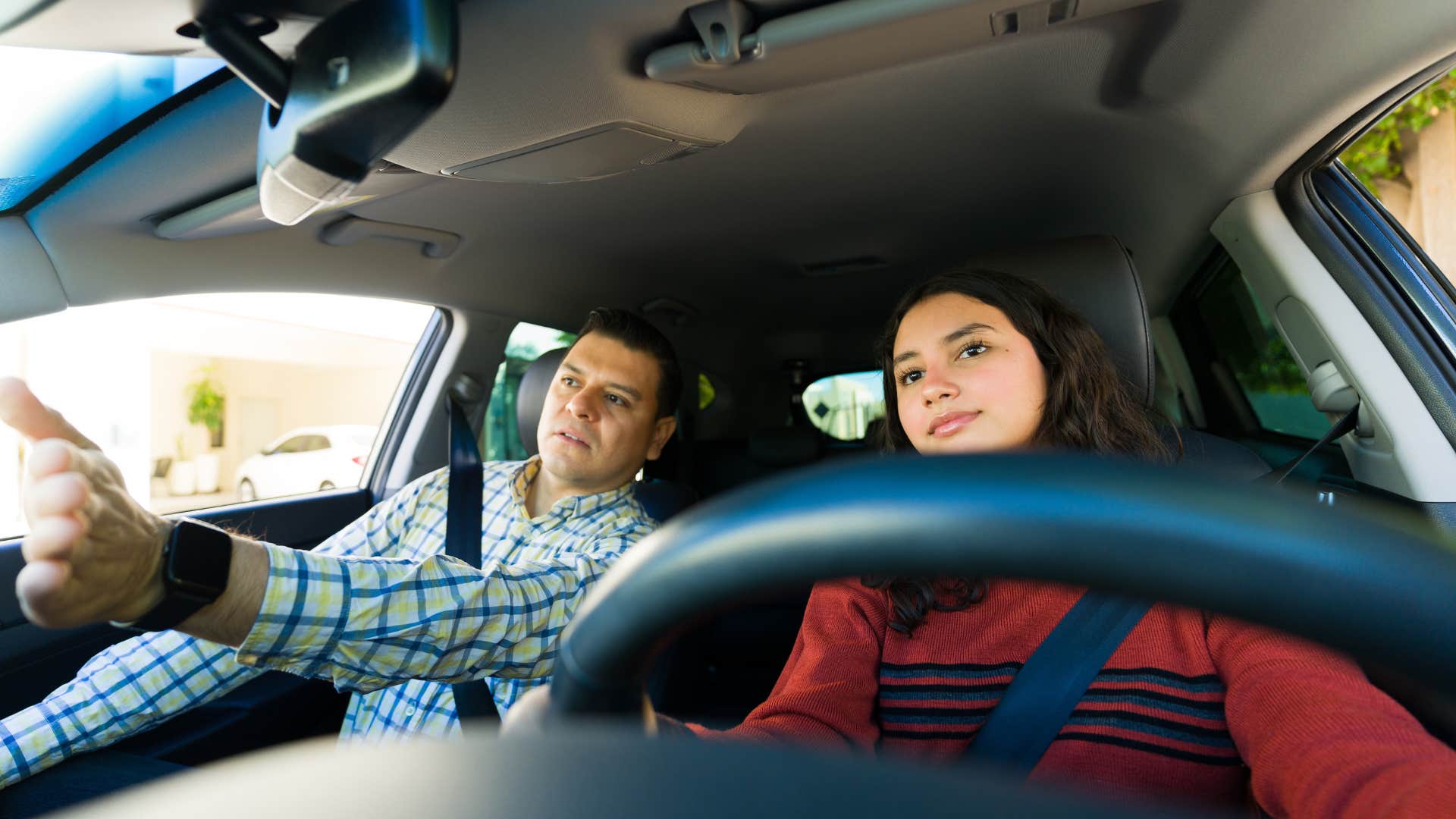 teen girl driving dad in car