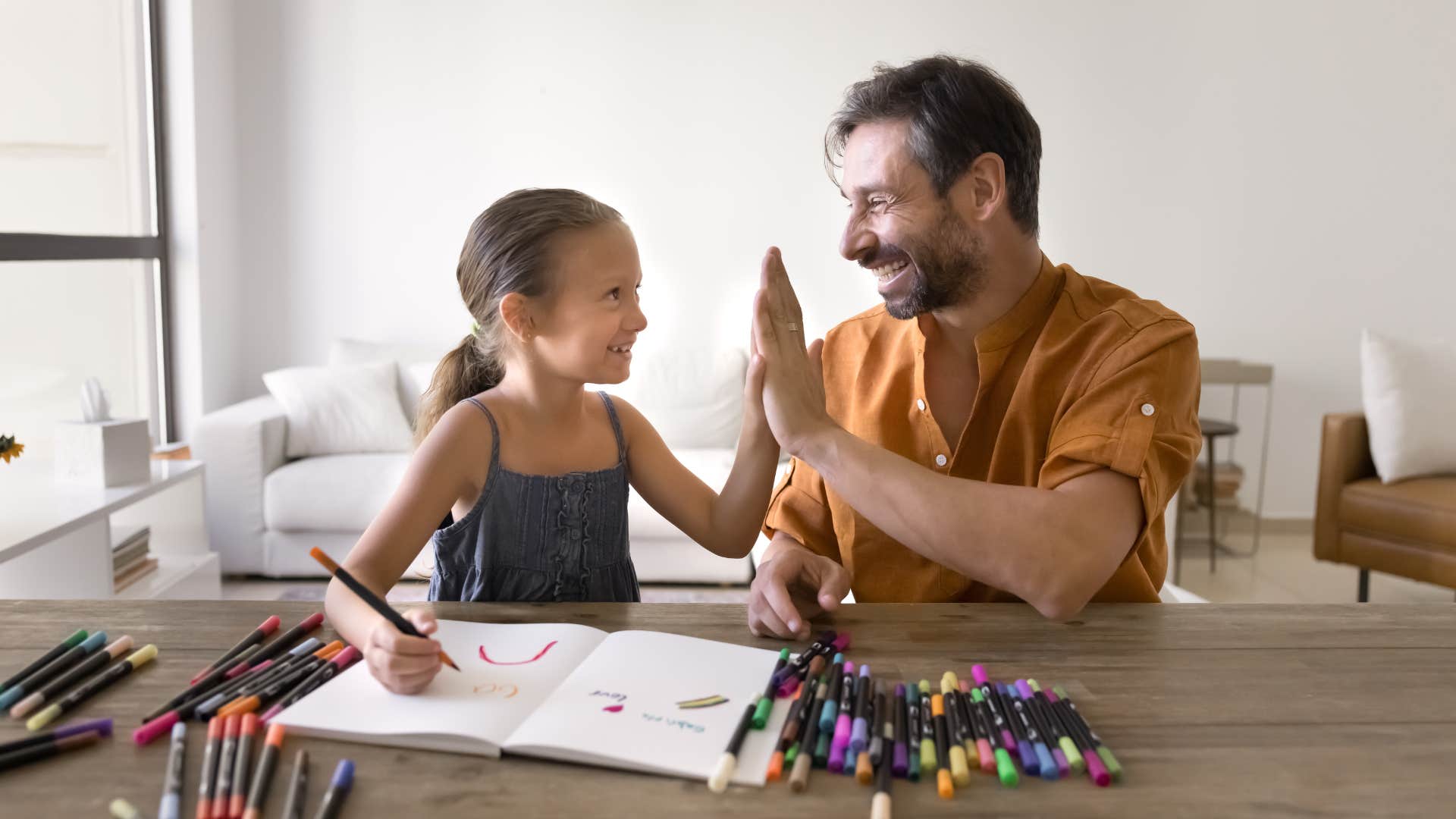 little girl getting praise from dad