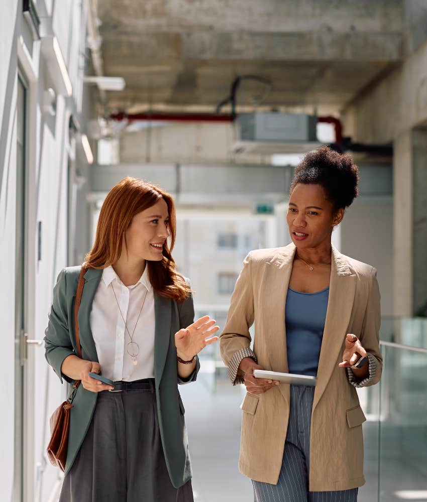 friendly female coworkers talking at work