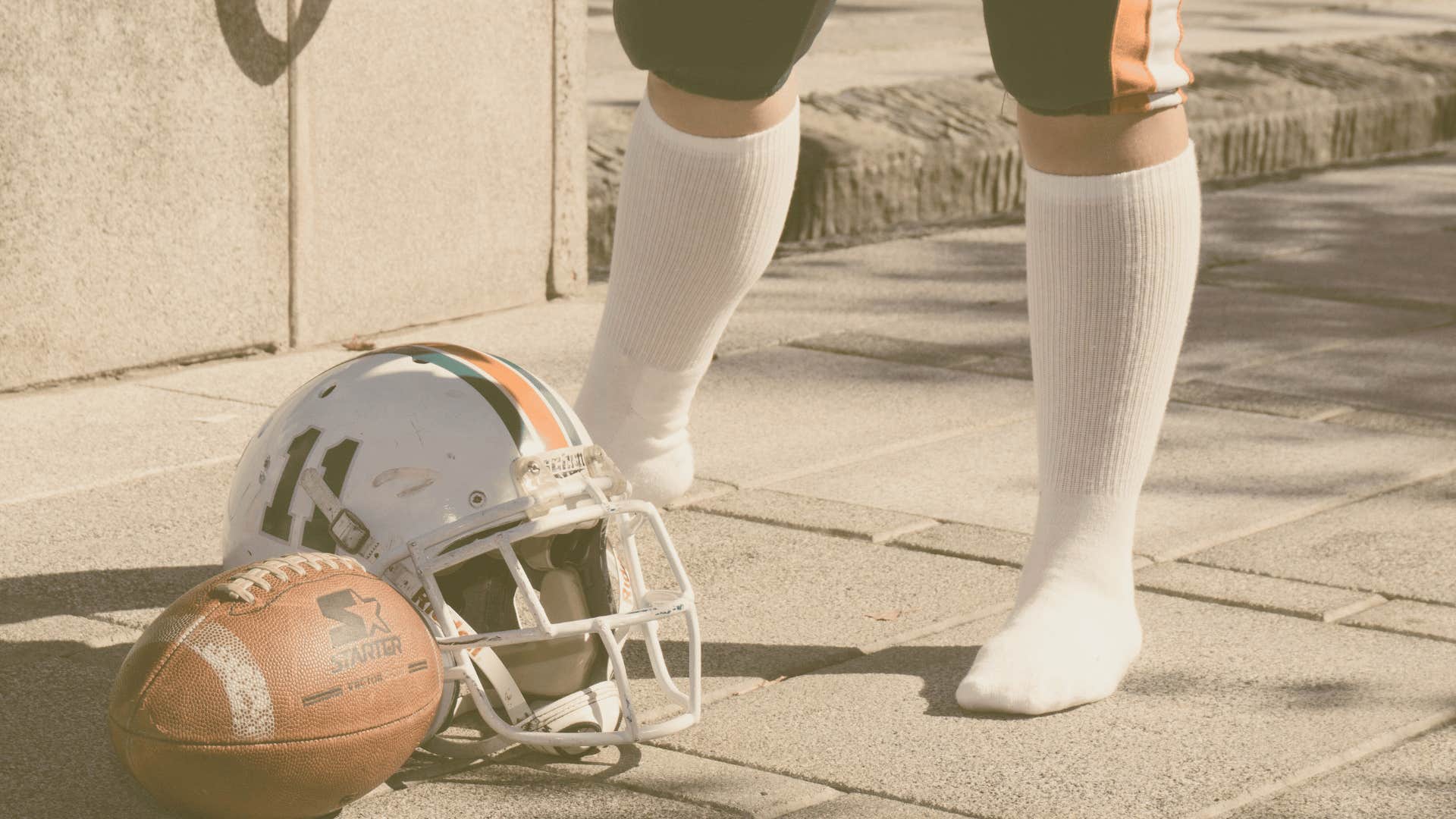 football and helmet lying on the ground
