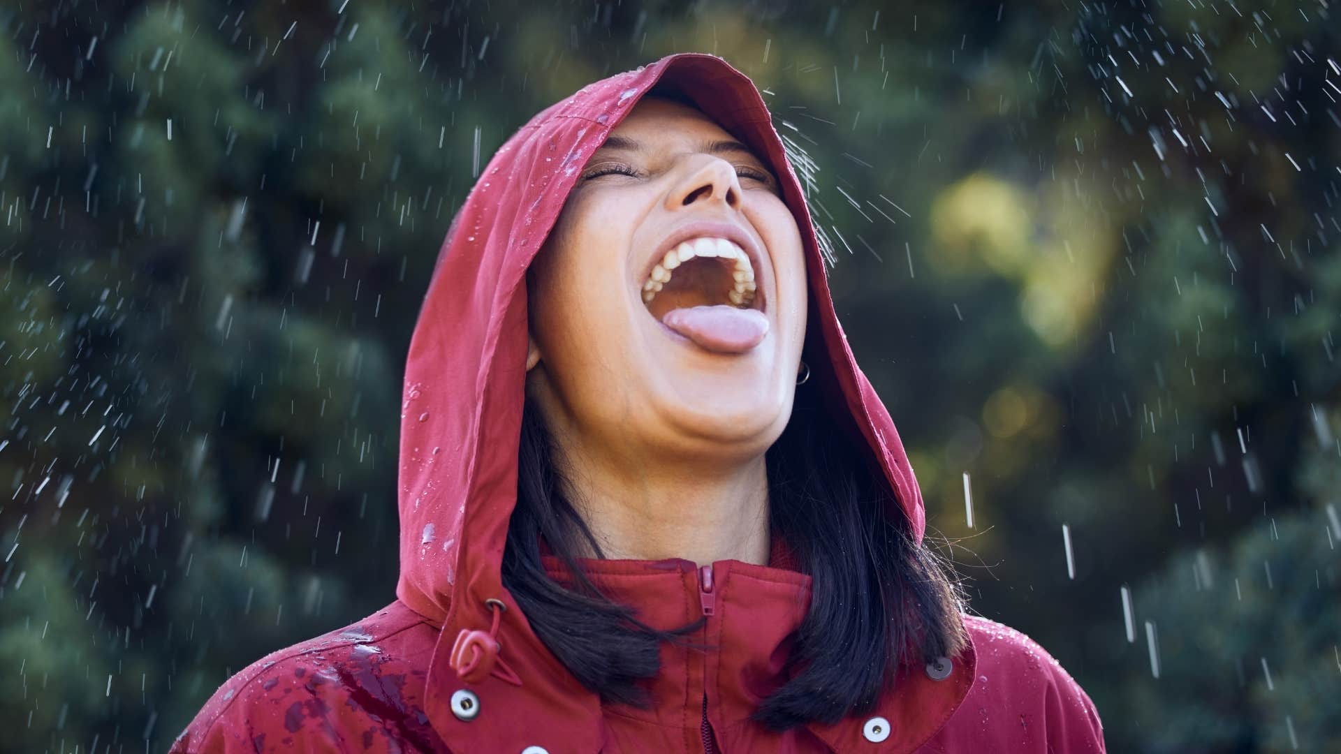 Joyful person on vacation slows down to taste the rainfall