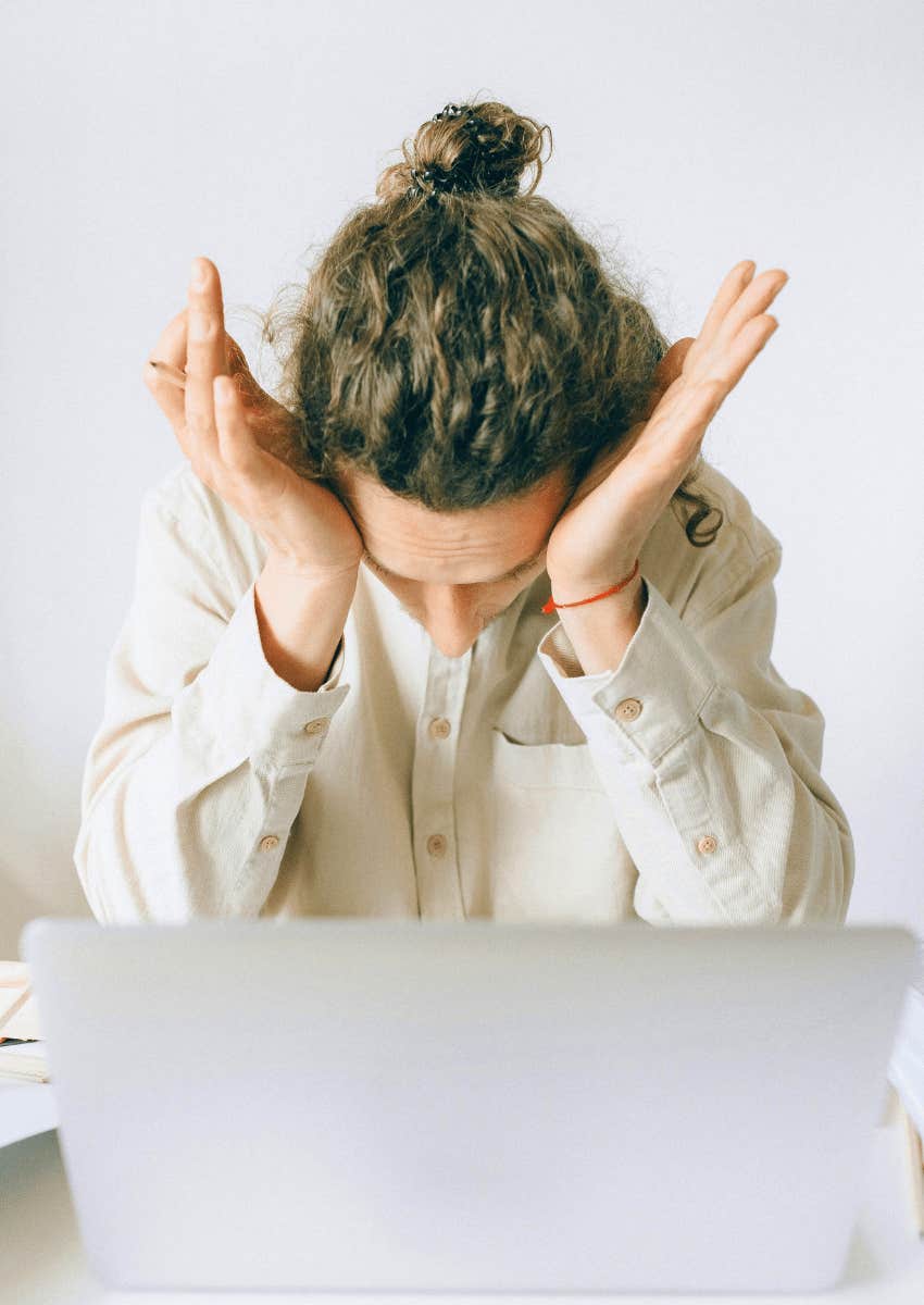 frustrated employee with his head in his hands