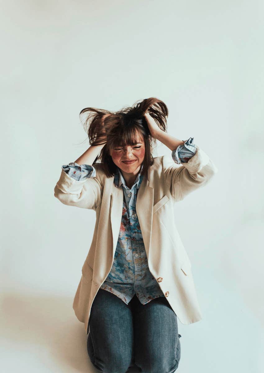 frustrated mom pulling her hair in frustration