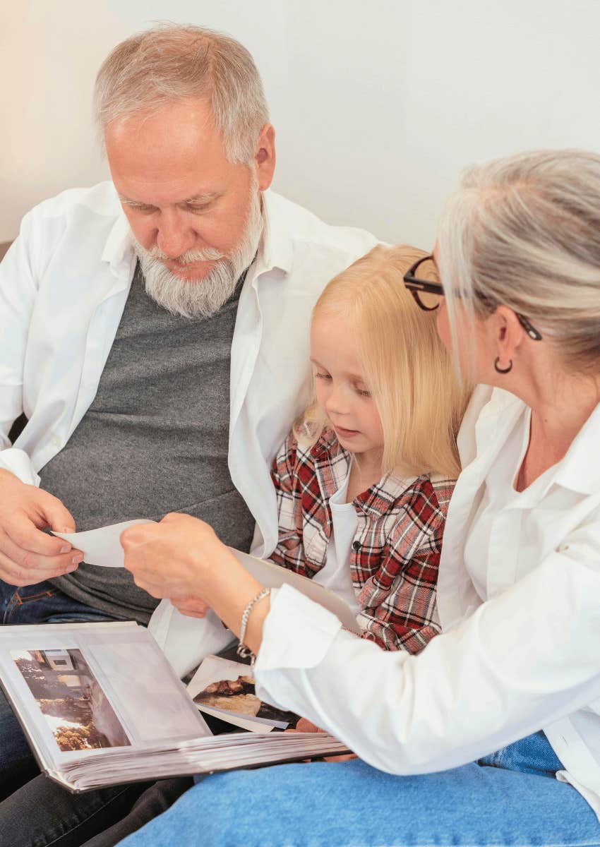 grandparents and grandchild looking through photo albums