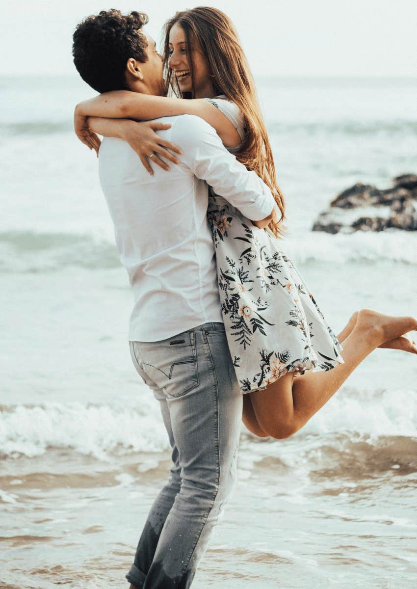 happy couple hugging on a beach