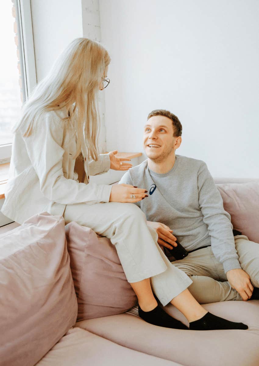 happy couple talking on couch