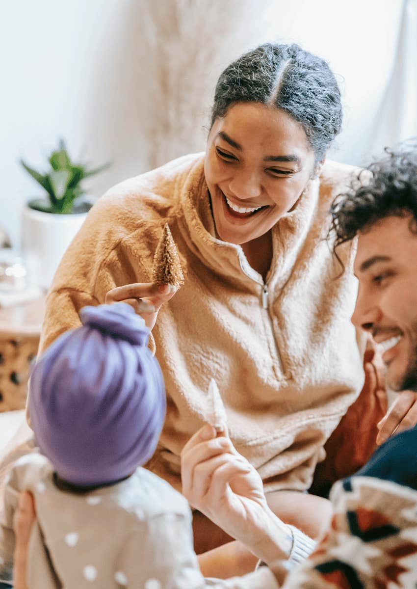 happy parents playing with their baby