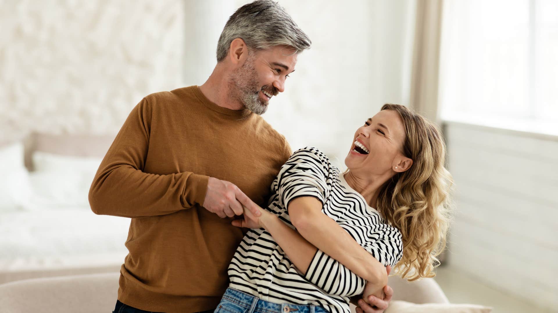 creative man dancing with his wife