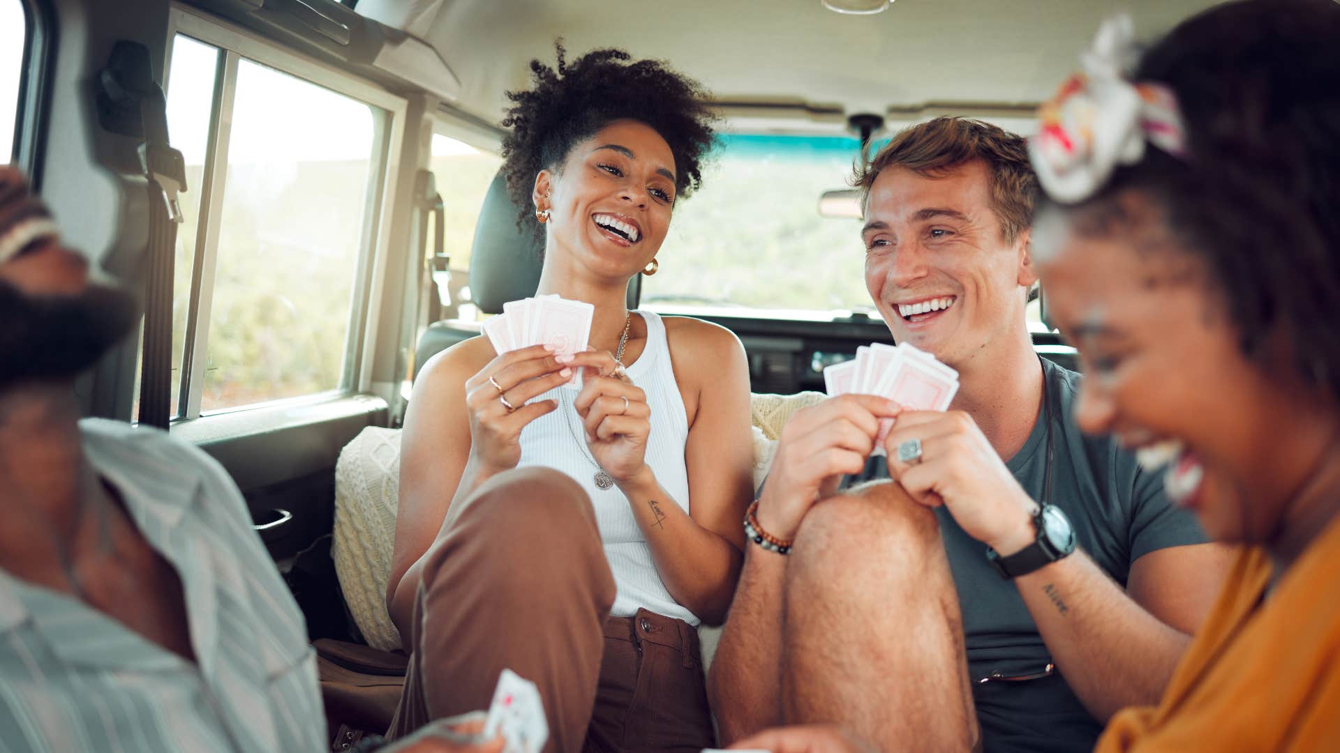 man playing cards and improvising with friends