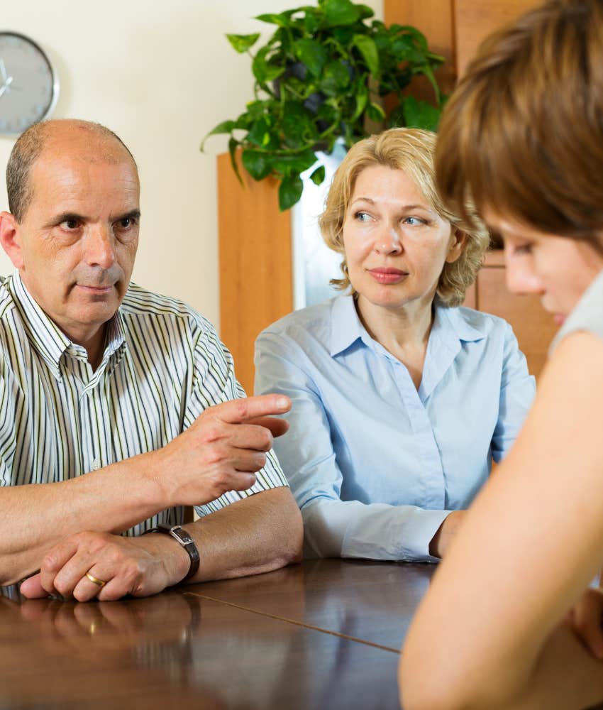 Stern parent points finger at adult child showing reason to go no contact