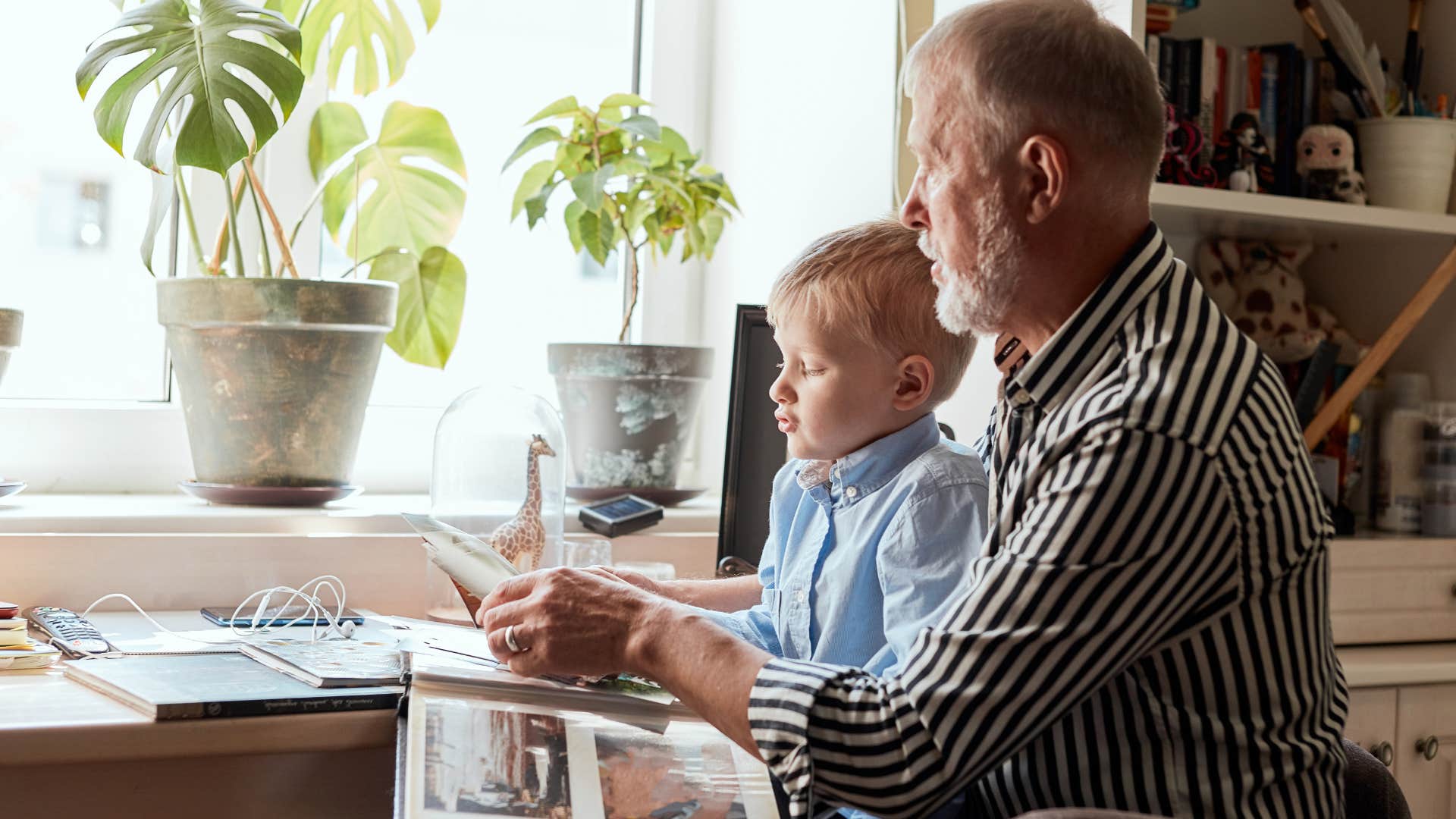 grandpa showing his grandson film photography