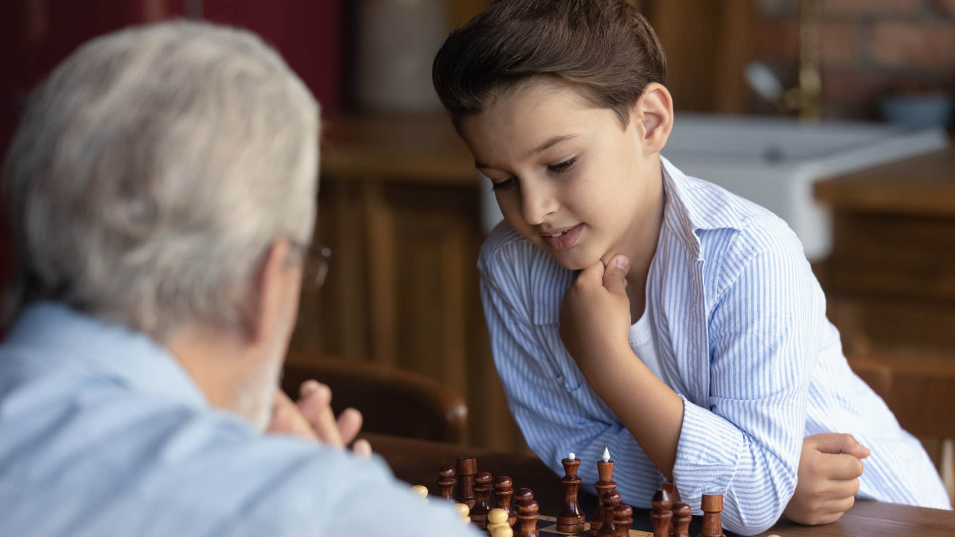 grandpa playing strategy games with his grandson