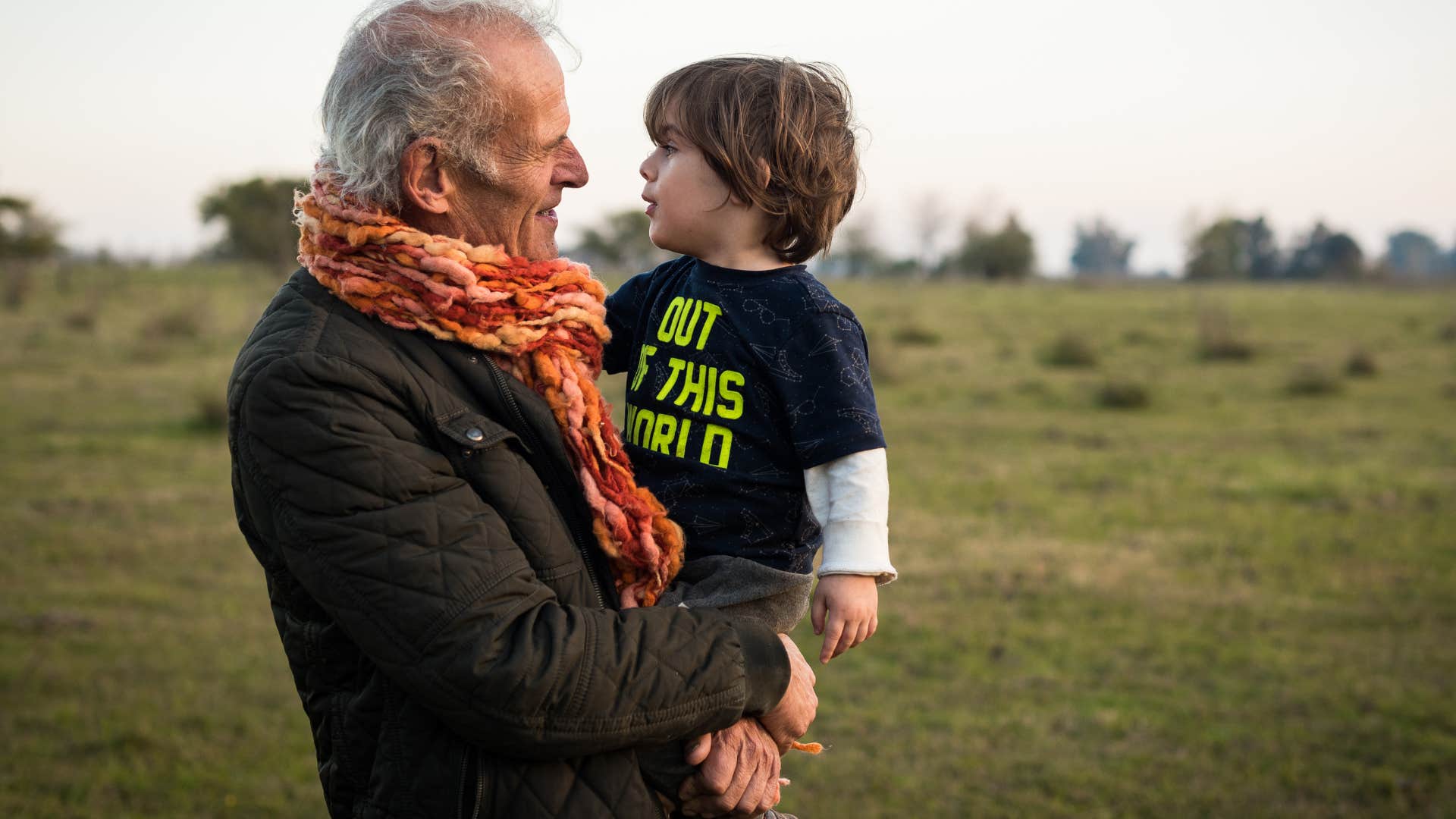grandpa treasure-hunting outside with his grandkid