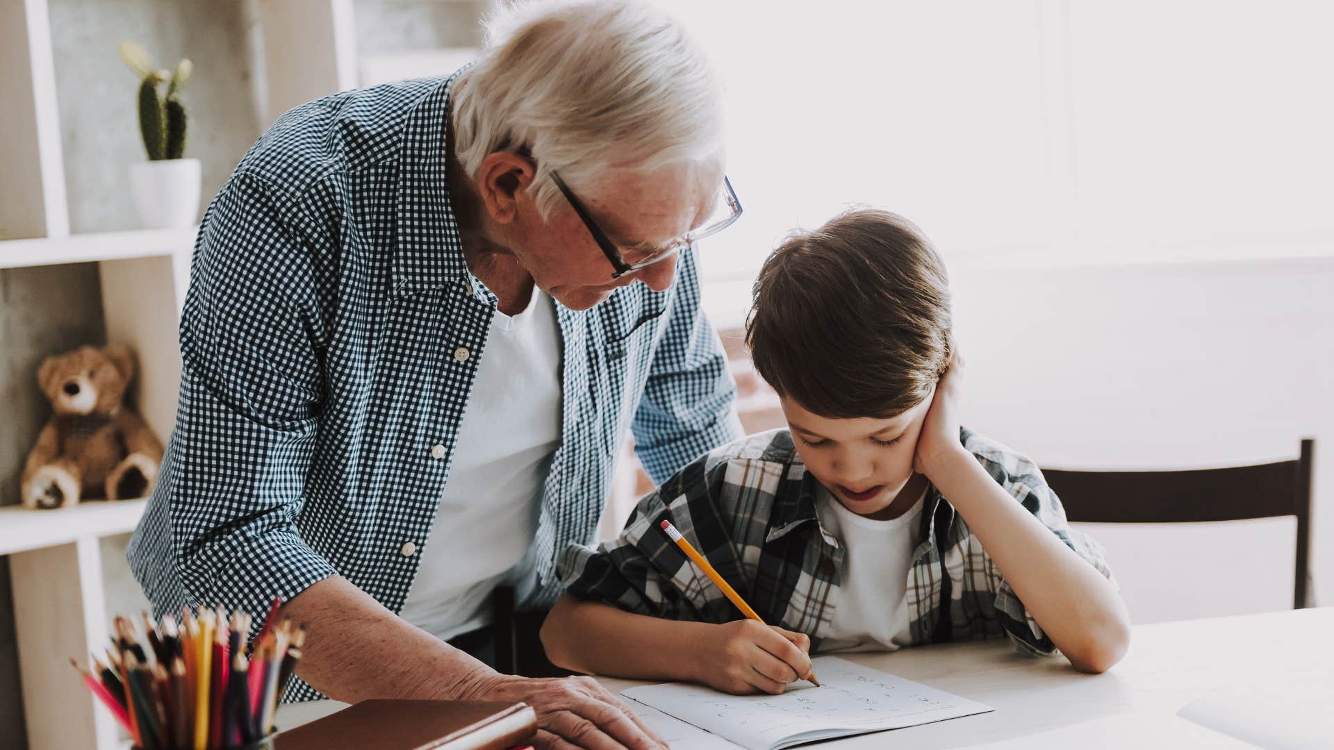 grandpa writing letters with his grandson