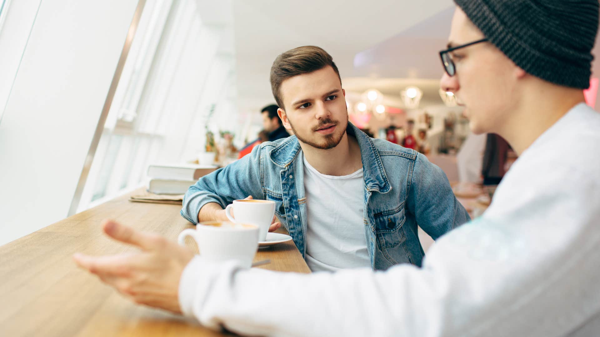 man telling friend you're reading into it too much over coffee