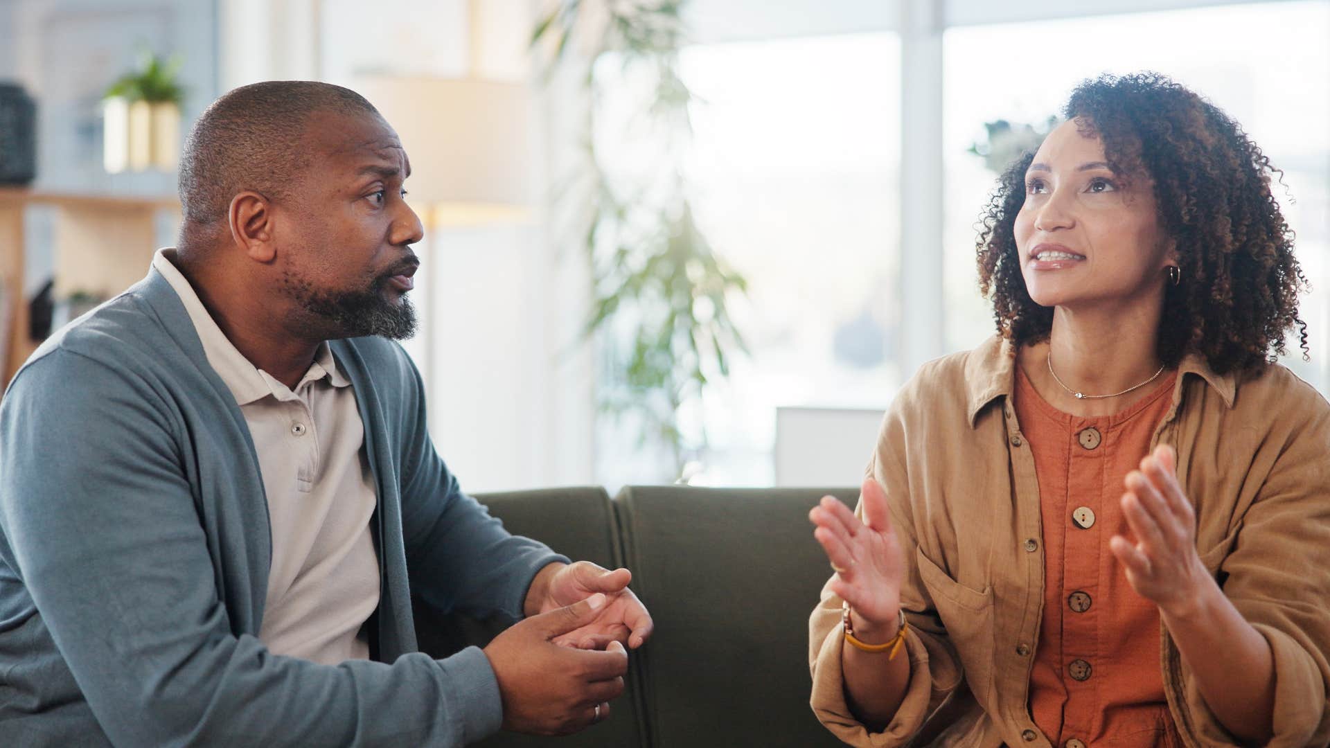 Focused couple talk with distance between them showing relationship hanging by a thread