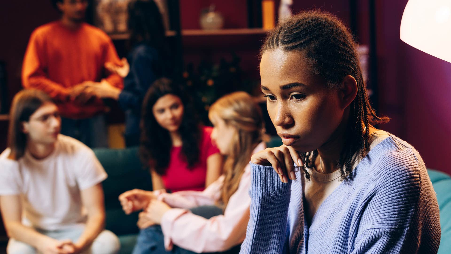 Upset person separates from friends showing relationship hanging by a thread