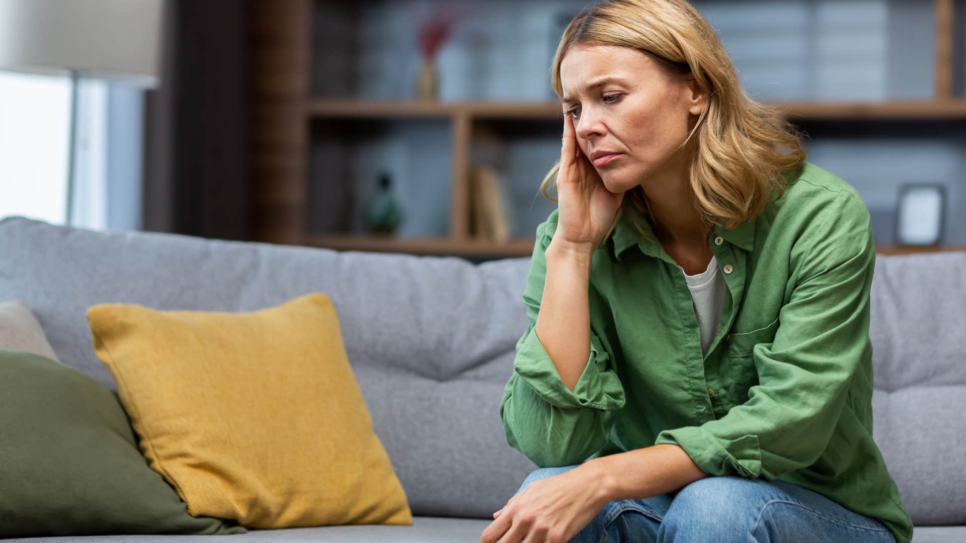 unhappy woman sitting alone at home