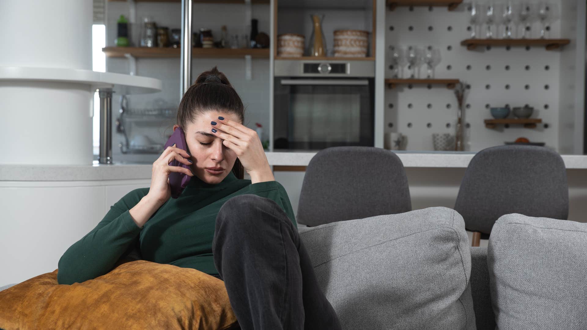 annoyed woman talking on the phone with person playing devil's advocate
