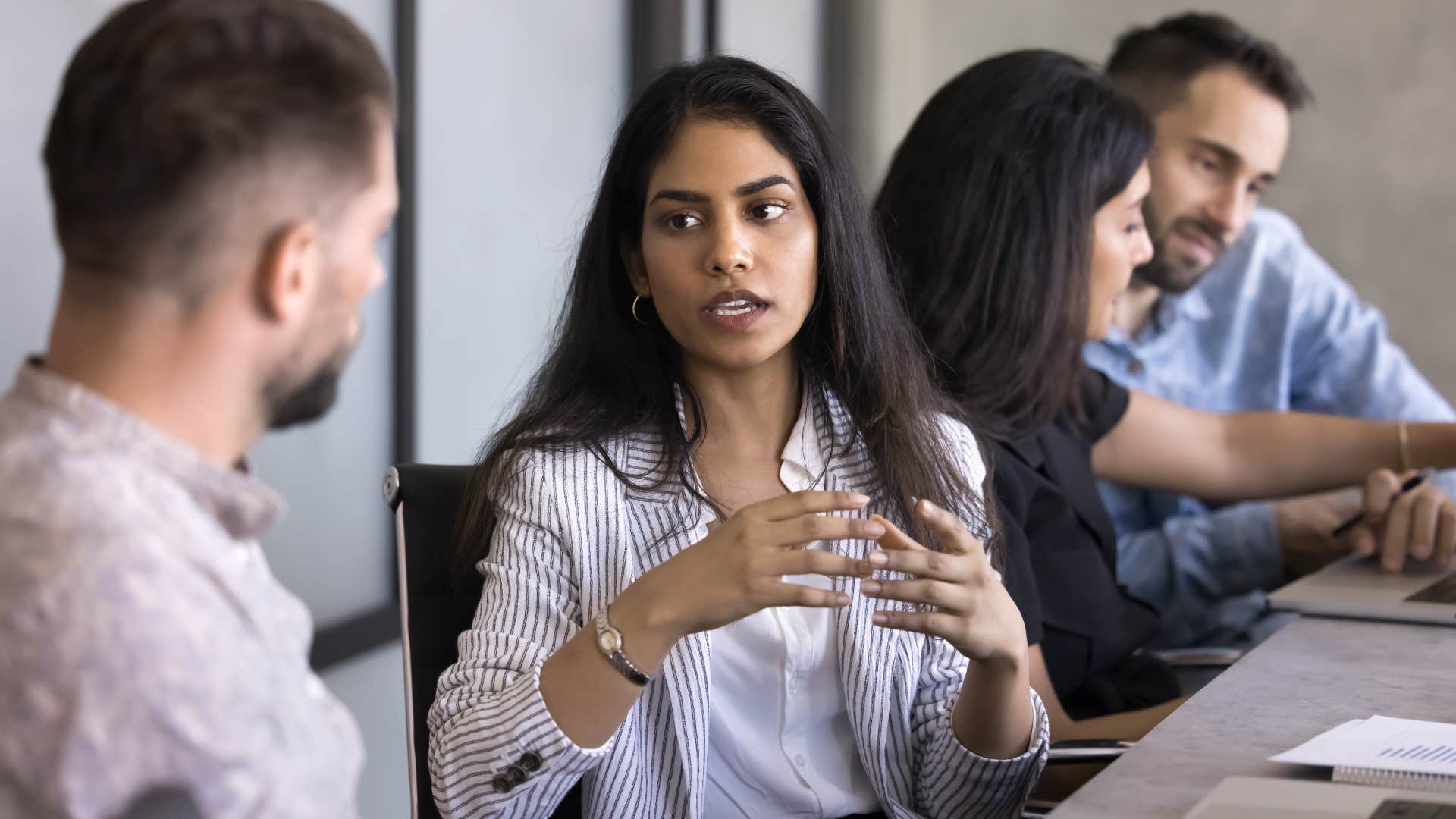 professional woman trying to manage her tasks praising co-worker