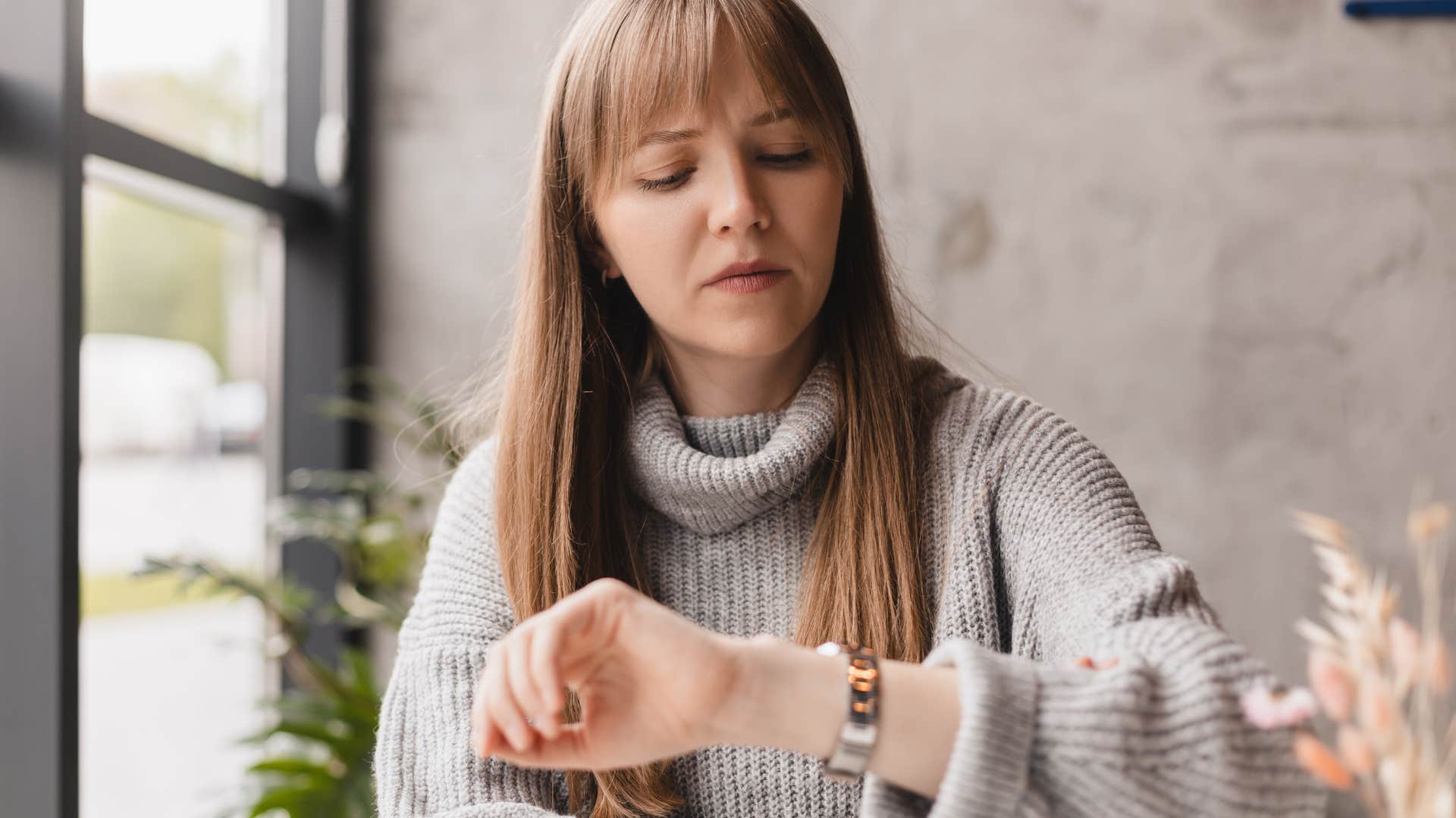 woman looking at watch running late