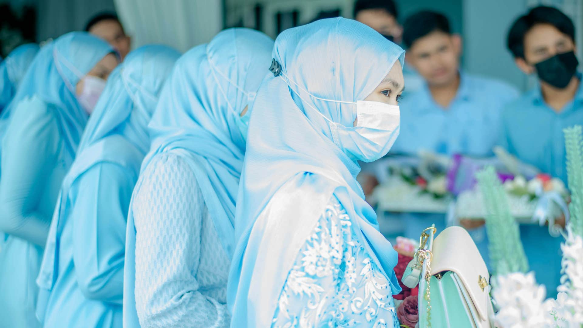 Wedding party members wear face masks showing not to show up sick to wedding 