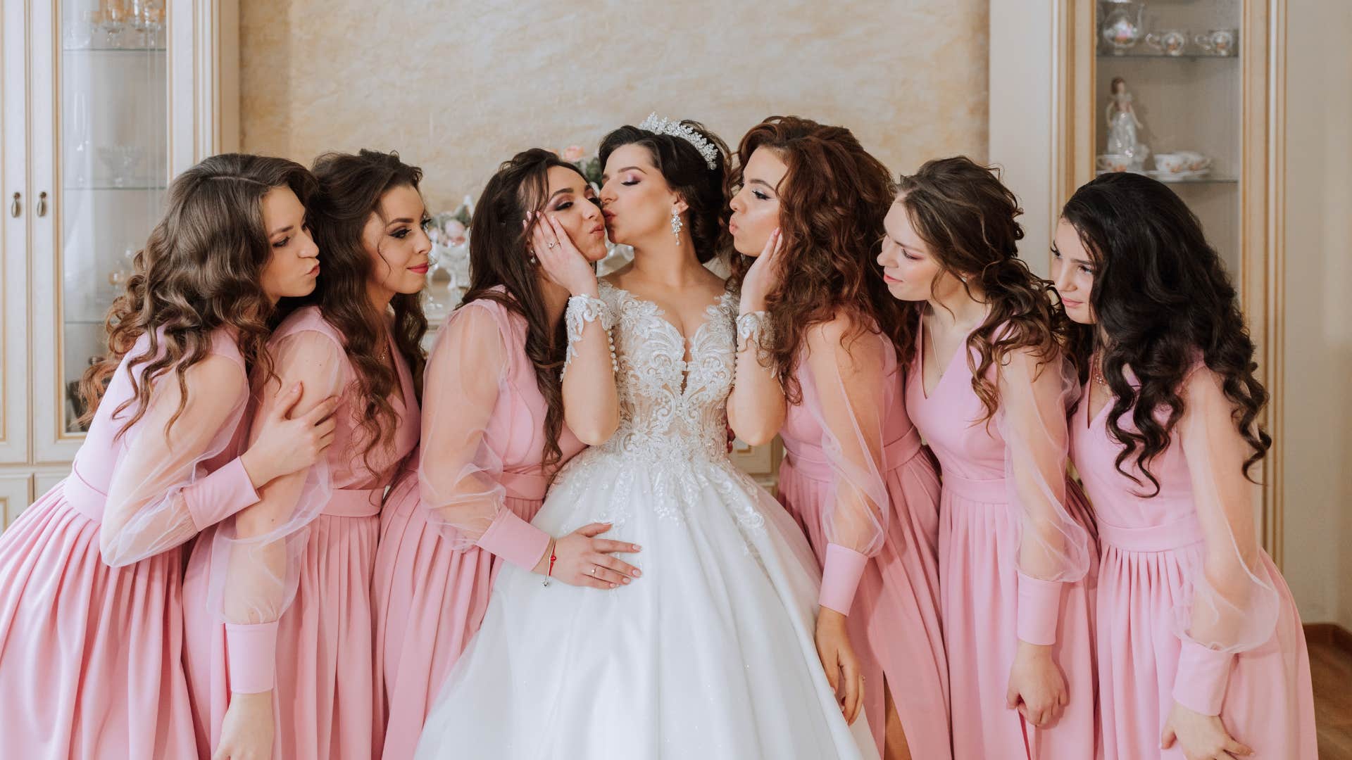 Beautiful bride and bridesmaids showing don't steal spotlight at wedding