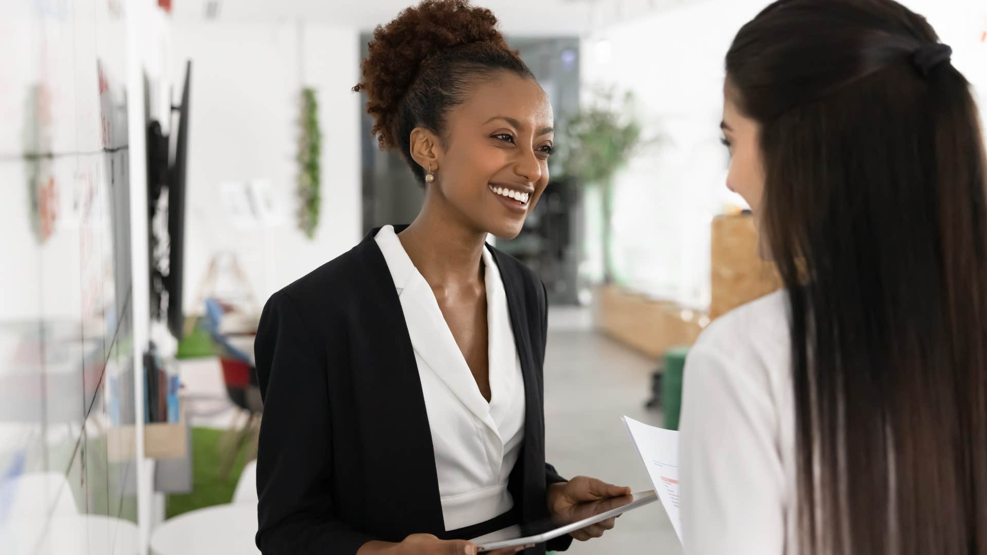 woman who keeps her word smiling with colleague