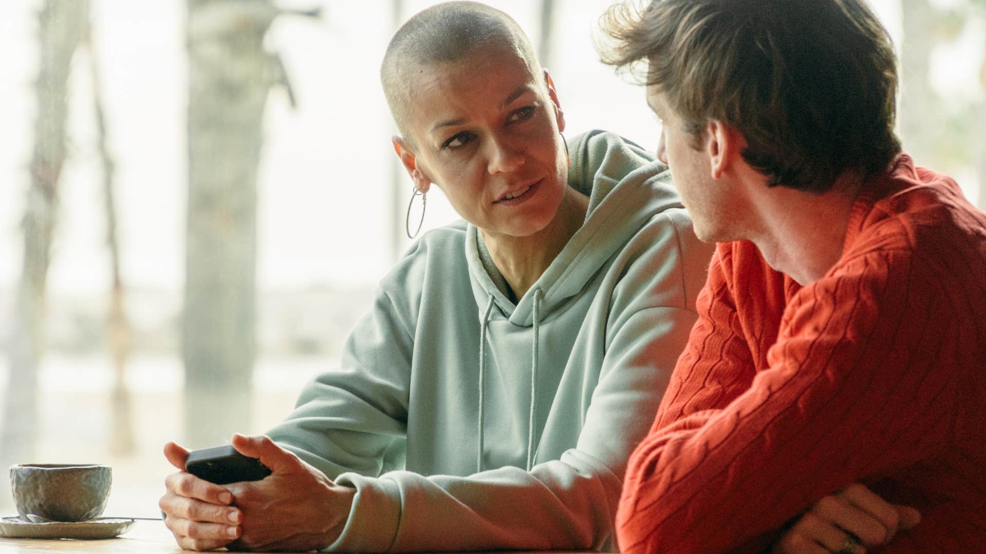 woman who stands up for people talking to a friend