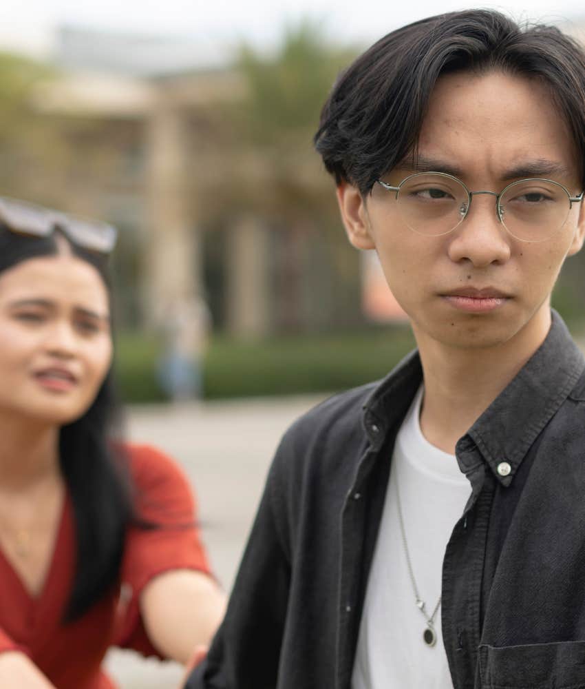 Upset person turns away from partner showing misery in relationship