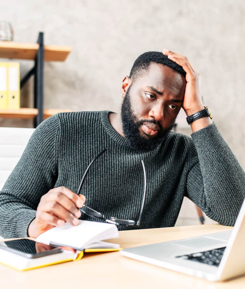 Frustraated person uses computer showing internet makes people lonelier