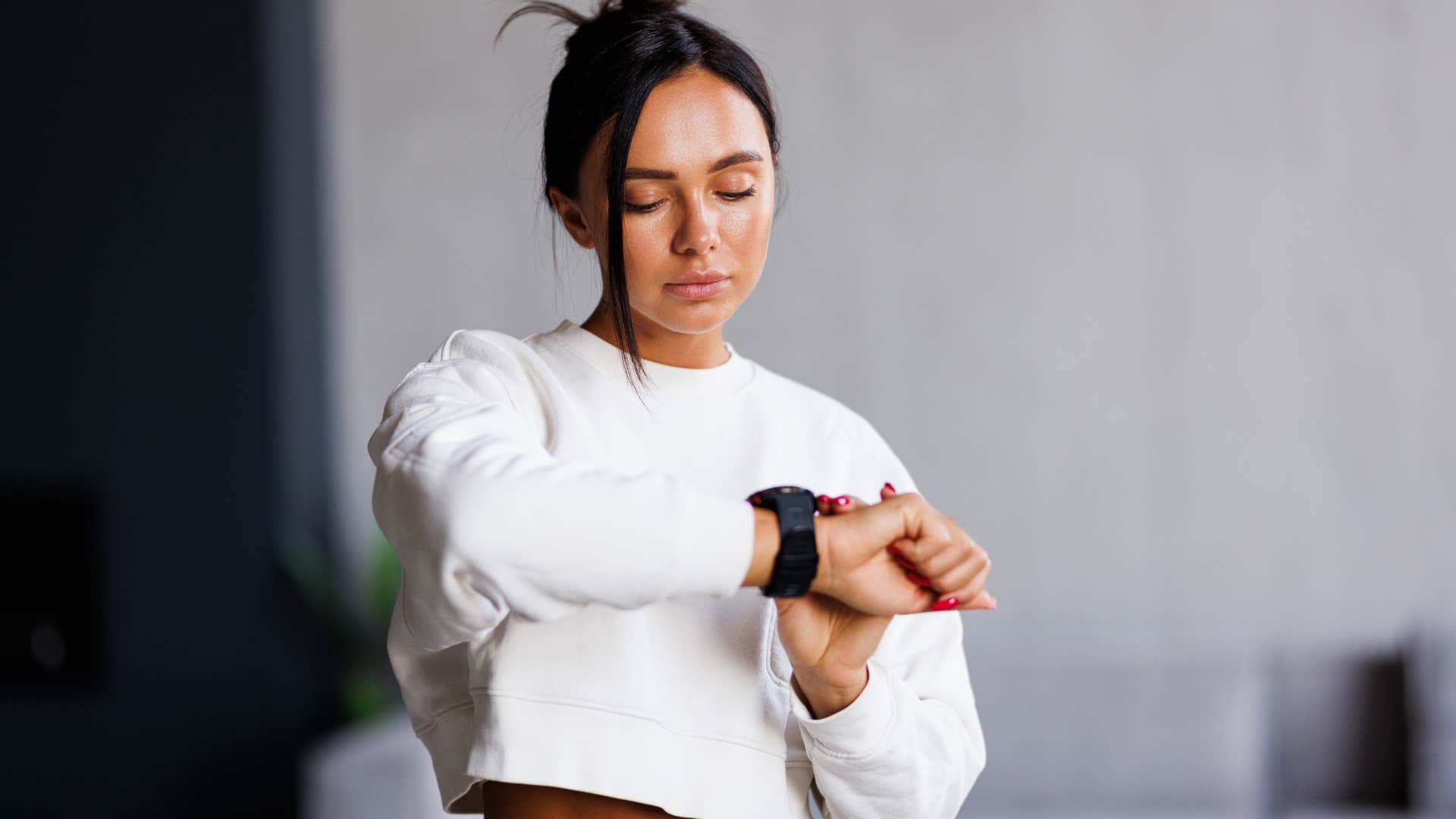 woman checking time on her watch waiting for late person